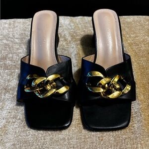 Patrizia Chic Black and Gold Chain Mules